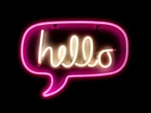hello lit up in a chat bubble in a neon sign